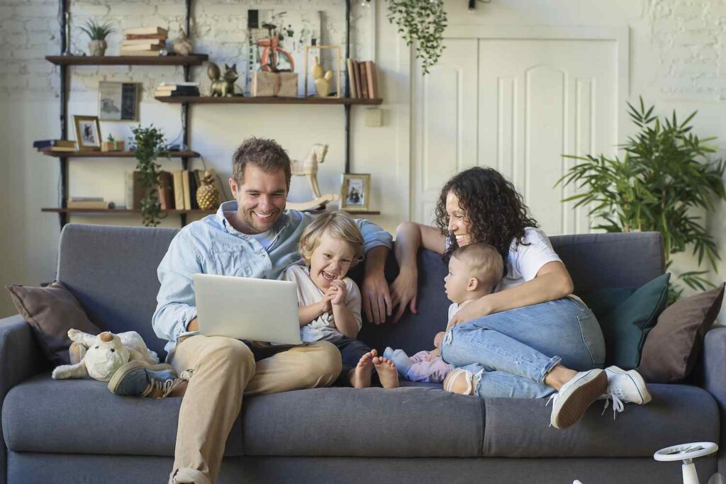 Happy family looking at house plans together for their new home in El Paso, TX