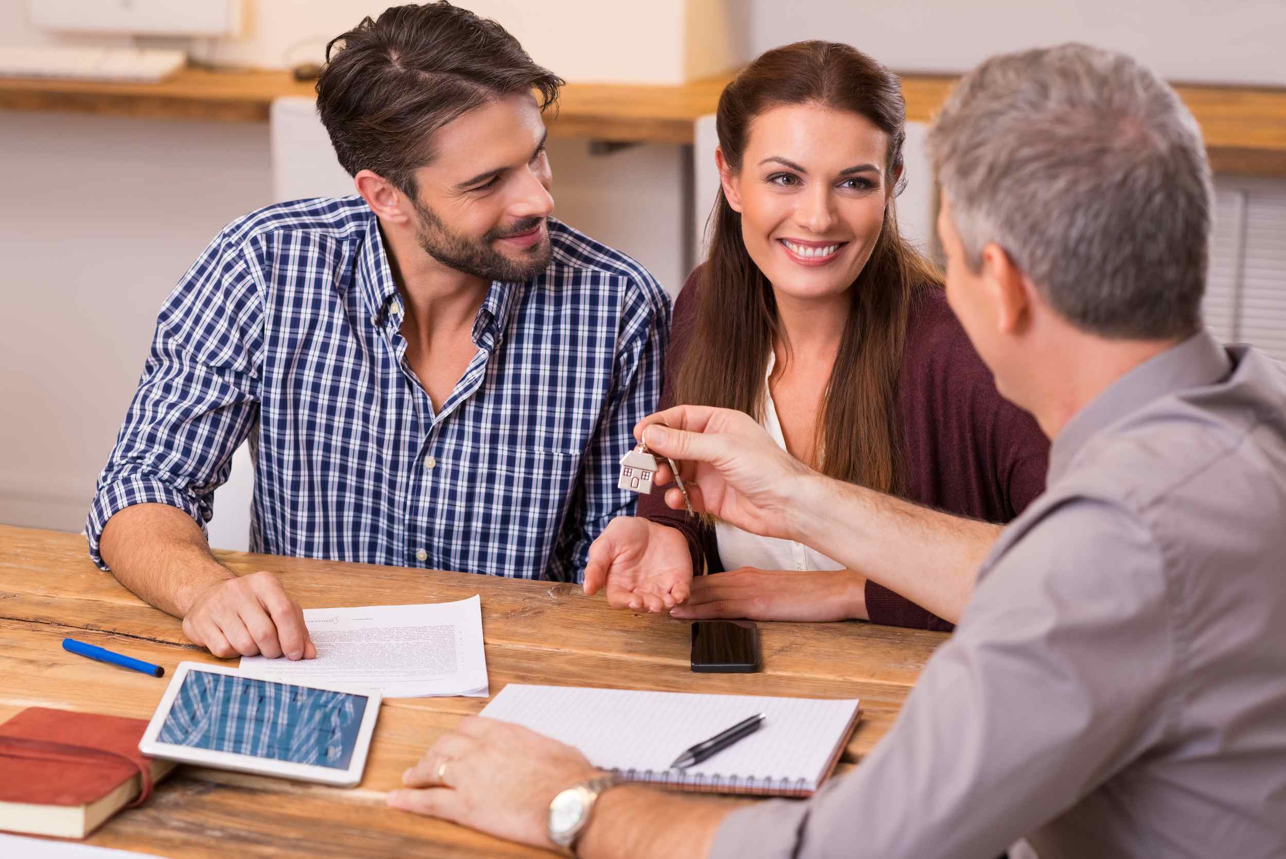 Couple discussing with a real estate agent in El Paso, TX office